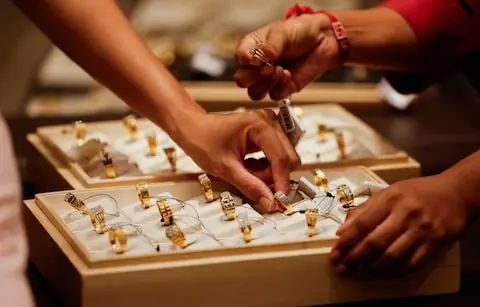 Gold breaks $4,100 to hit high on trade jitters, rate-cut optimism